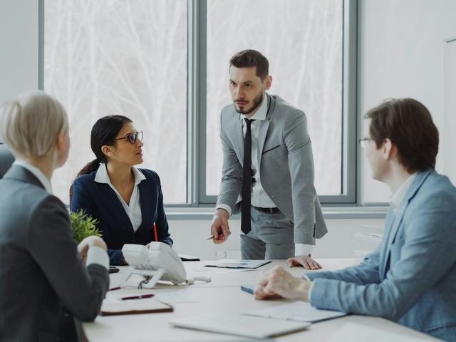 Colleagues discussing plans together in a bright meeting room